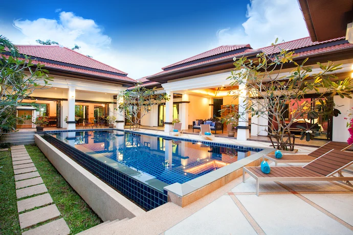 Luxury home with beautiful columns, porch, and swimming pool