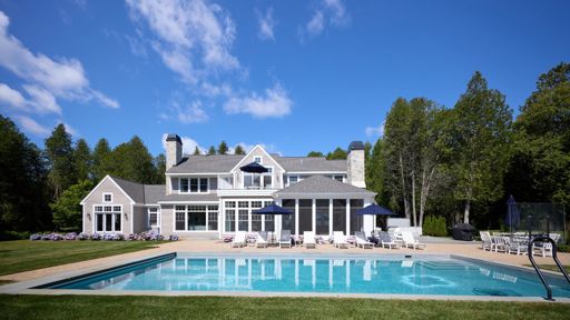 White and grey home with pool