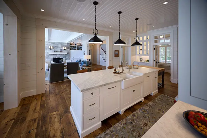 Kitchen with white island and industrial lights