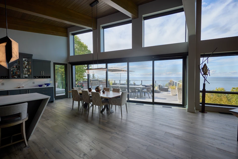 open concept living room with wood flooring and large accessible doors