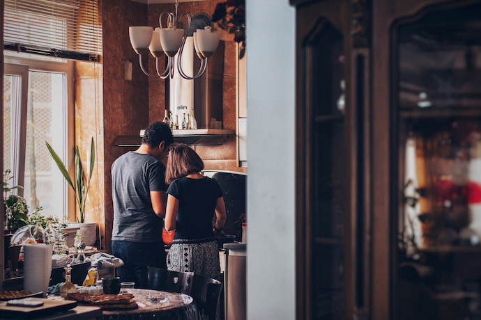 a couple hugging in the kitchen